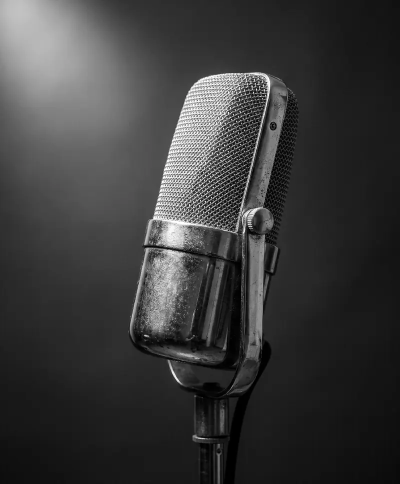 A vintage microphone in a spotlight